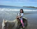 Child riding horses on Zihuatanejo beach